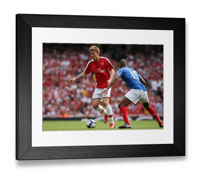 Framed Print : Nicklas Bendtner (Arsenal) Sylvain Distin (Portsmouth) Framed Print : Nicklas Bendtner (Arsenal) Sylvain Distin (Portsmouth)