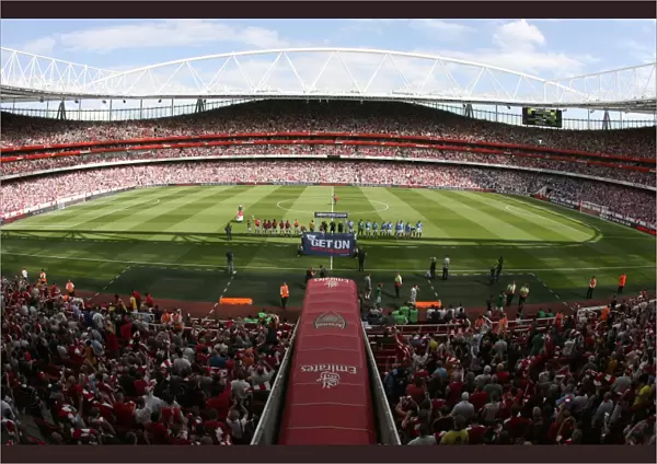 The Arsenal and Portsmouth Teams line up before the match
