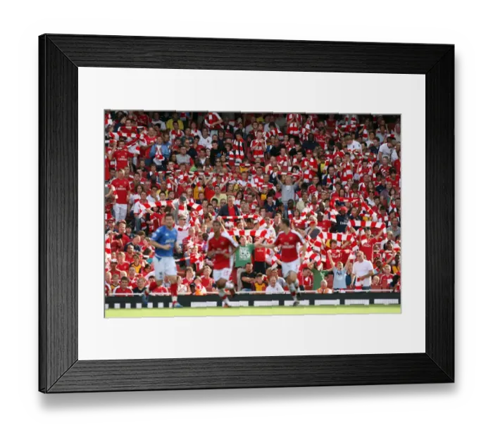 Framed Print : Arsenal fans hold up their scarves
