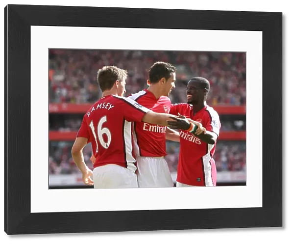 Arsenal's Unstoppable Force: Ramsey, van Persie, and Eboue Celebrate a 4-1 Victory Over Portsmouth