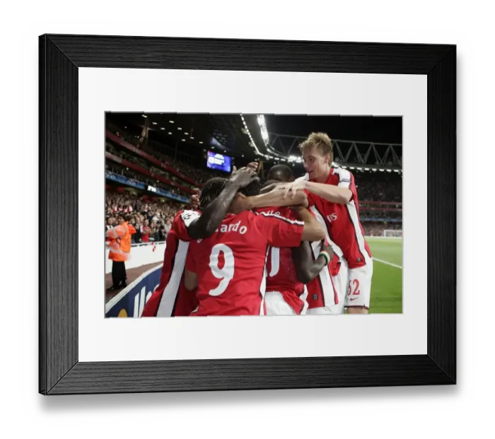 Framed Print : Arsenal's Unforgettable Victory: Emmanuel Eboue's Exultant Moment after Scoring the Decisive Goal vs Celtic in the UEFA Champions League (2009)