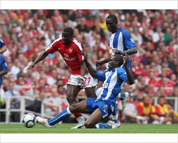 Emmanuel Eboue (Arsenal) Hendry Thomas and Mohamed Diame (Wigan)