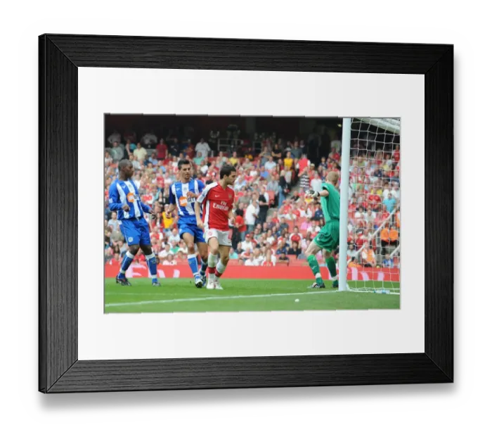 Framed Print : Cesc Fabregas shoots past Wigan goalkeeper Chris Kirkland