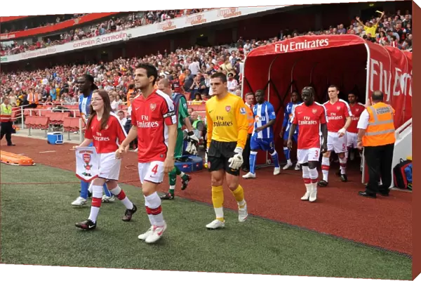 Arsenal captain Cesc Fabregas followed by Vito Mannone