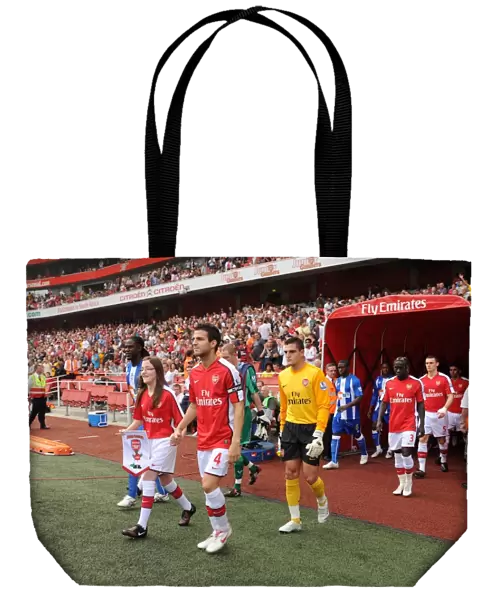 Arsenal captain Cesc Fabregas followed by Vito Mannone