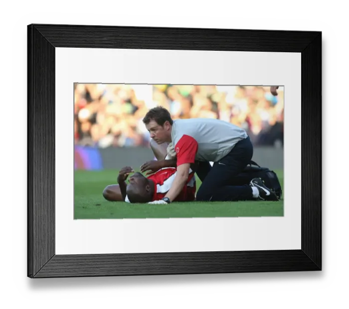 Framed Print : Arsenal: Colin Lewin Tends to William Gallas Injury during Fulham Match Framed Print : Arsenal: Colin Lewin Tends to William Gallas Injury during Fulham Match