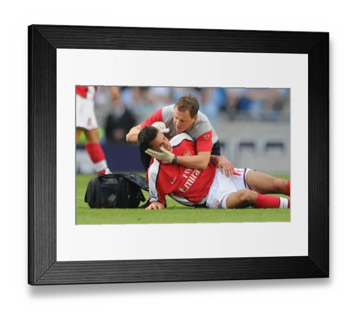 Framed Print : Manchester Derby Agony: Van Persie vs Adebayor Clash (2009) - Arsenal's Robin Suffers Head Injury at City's Hands