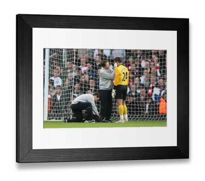 Framed Print : Arsenal goalkeeper Vito Mannone it treated by physio Colin Lewin Framed Print : Arsenal goalkeeper Vito Mannone it treated by physio Colin Lewin