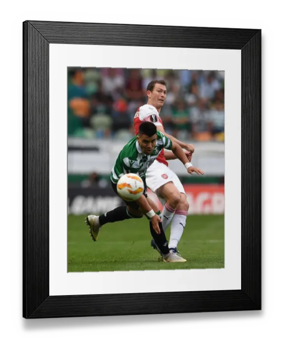 Framed Print : Stephan Lichtsteiner vs Marcos Acuna: Clash in the Europa League Between Sporting Lisbon and Arsenal