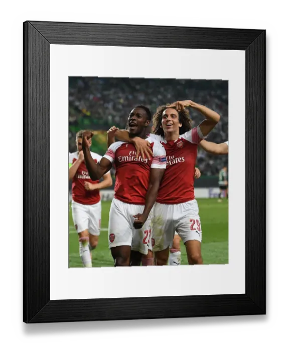 Framed Print : Arsenal's Welbeck and Guendouzi Celebrate Goal in Europa League Match against Sporting Lisbon