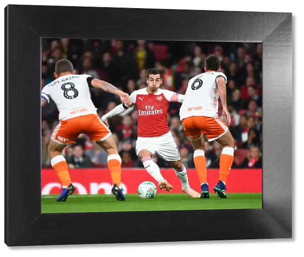 Arsenal's Mkhitaryan Faces Off Against Blackpool's Spearing and Heneghan in Carabao Cup Clash