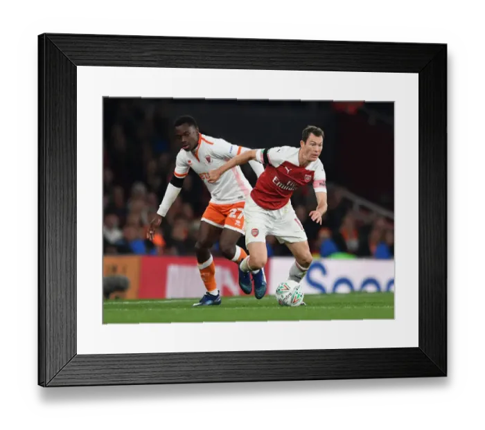 Framed Print : Arsenal's Lichtsteiner Clashes with Blackpool's Bola in Carabao Cup Showdown Framed Print : Arsenal's Lichtsteiner Clashes with Blackpool's Bola in Carabao Cup Showdown