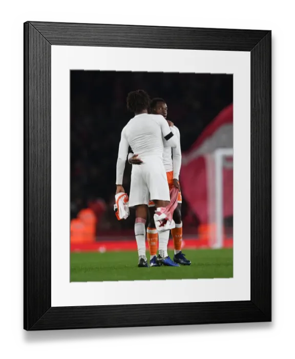 Framed Print : Arsenal's Alex Iwobi and Marc Bola of Blackpool Exchange Shirts After Carabao Cup Match Framed Print : Arsenal's Alex Iwobi and Marc Bola of Blackpool Exchange Shirts After Carabao Cup Match