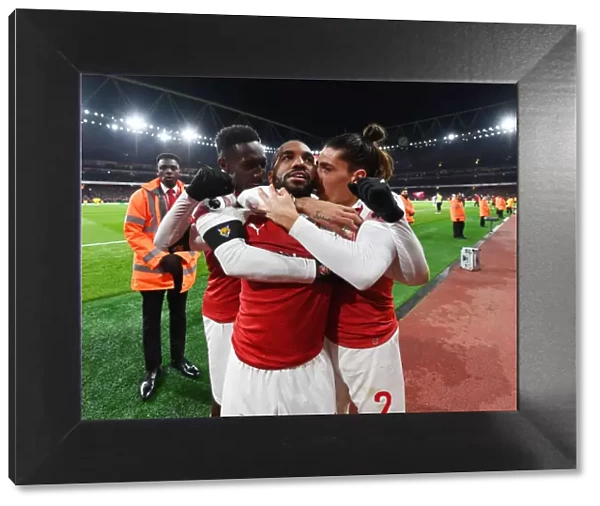 Triumphant Arsenal: Lacazette, Welbeck, and Bellerin Celebrate Goal Against Liverpool (2018-19)