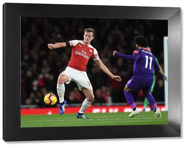 Mohamed Salah Closes In on Rob Holding: Intense Battle at Arsenal's Emirates Stadium