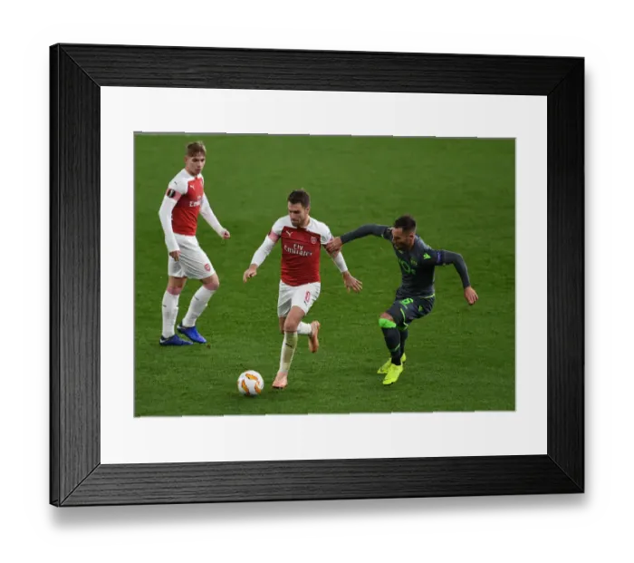 Framed Print : Clash of Midfield Maestros: Ramsey vs. Gudelj in Arsenal's Europa League Battle Framed Print : Clash of Midfield Maestros: Ramsey vs. Gudelj in Arsenal's Europa League Battle
