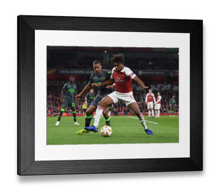 Framed Print : Arsenal's Alex Iwobi Fends Off Sporting's Bruno Gasper in Europa League Clash