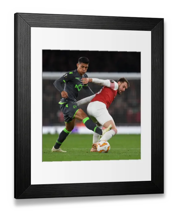 Framed Print : Clash of Midfielders: Ramsey vs. Montero in Arsenal's Europa League Battle Framed Print : Clash of Midfielders: Ramsey vs. Montero in Arsenal's Europa League Battle
