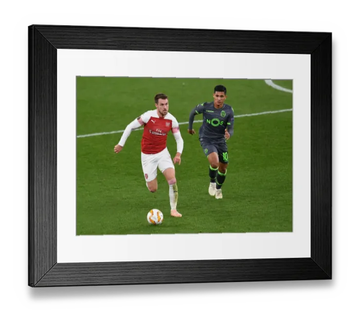Framed Print : Arsenal's Aaron Ramsey Clashes with Sporting CP's Fredy Montero in Europa League Showdown Framed Print : Arsenal's Aaron Ramsey Clashes with Sporting CP's Fredy Montero in Europa League Showdown
