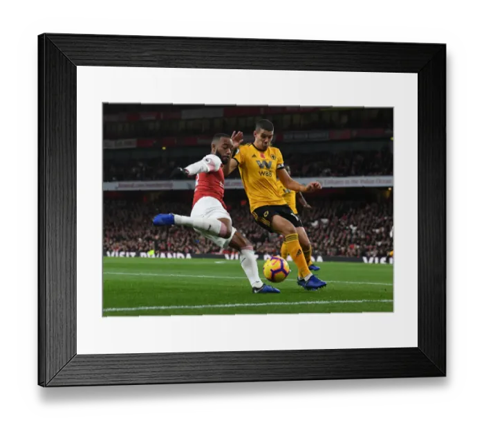 Framed Print : Arsenal's Lacazette Clashes with Wolverhampton's Coady in Premier League Showdown