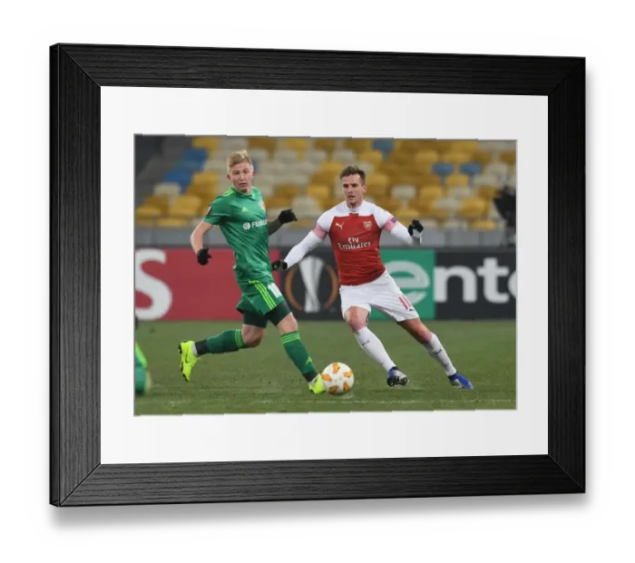 Framed Print : Rob Holding vs Vladyslav Kulach: Battle for Ball Possession in Arsenal's Europa League Clash with Vorskla Poltava