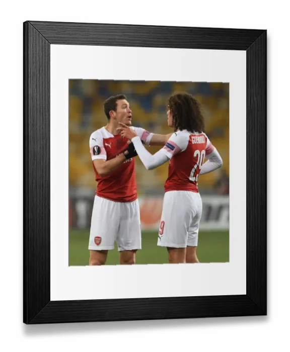 Framed Print : Arsenal's Guendouzi and Lichtsteiner in Action during Europa League Match against Vorskla Poltava Framed Print : Arsenal's Guendouzi and Lichtsteiner in Action during Europa League Match against Vorskla Poltava
