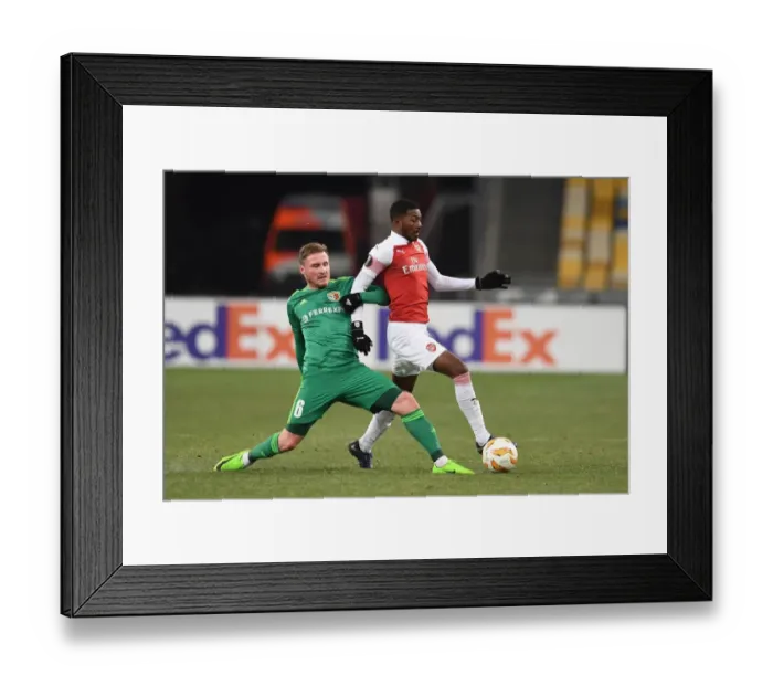 Framed Print : Ainsley Maitland-Niles vs. Oleksandr Skliar: A Battle in the Europa League Clash between Arsenal and Vorskla Poltava