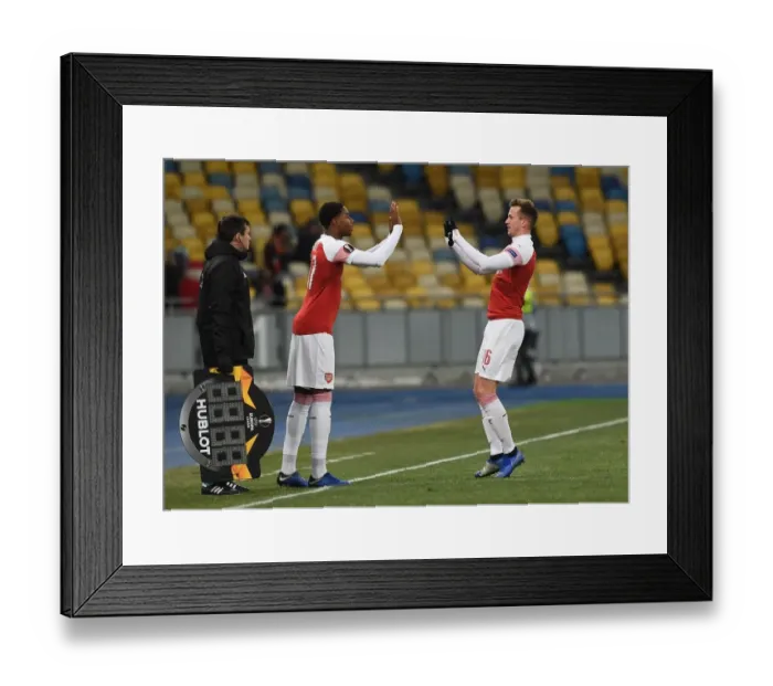 Framed Print : Rob Holding and Zech Medley: A Moment of Camaraderie in Arsenal's UEFA Europa League Match against Vorskla Poltava