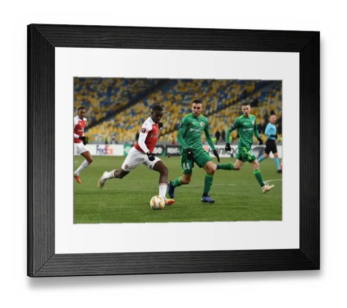 Framed Print : Arsenal's Eddie Nketiah Faces Off Against Vorskla's Ardin Dallku in Europa League Clash Framed Print : Arsenal's Eddie Nketiah Faces Off Against Vorskla's Ardin Dallku in Europa League Clash