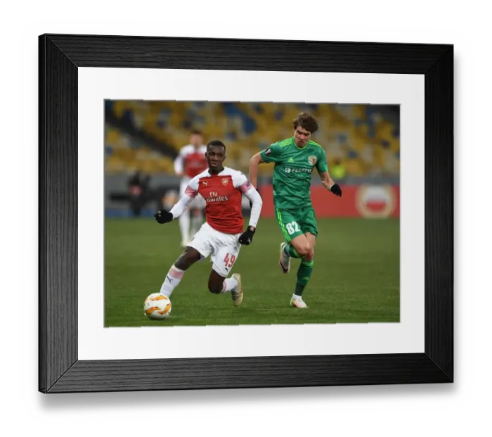 Framed Print : Arsenal's Eddie Nketiah Clashes with Pavlo Rebenok of Vorskla in Europa League Match