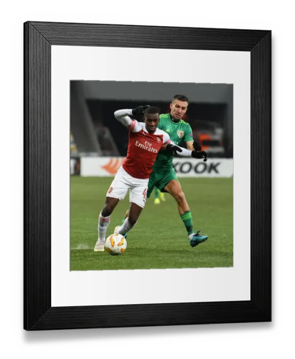Framed Print : Joe Willock vs. Vyacheslav Sharpar: Arsenal's Midfielder Stands Off Against Vorskla's Defender in Europa League Clash Framed Print : Joe Willock vs. Vyacheslav Sharpar: Arsenal's Midfielder Stands Off Against Vorskla's Defender in Europa League Clash