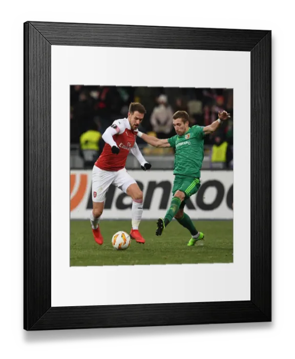 Framed Print : Arsenal's Aaron Ramsey Faces Off Against Vorskla's Lurii Kolomoets in Europa League Clash Framed Print : Arsenal's Aaron Ramsey Faces Off Against Vorskla's Lurii Kolomoets in Europa League Clash