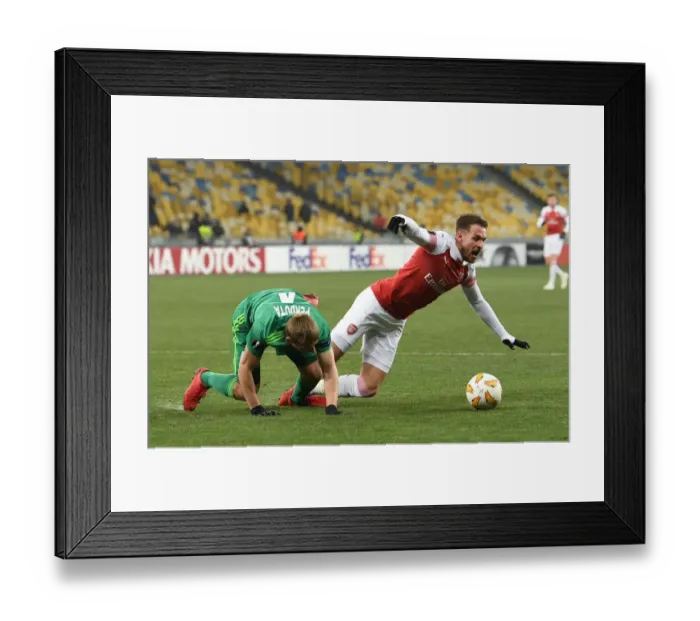 Framed Print : Aaron Ramsey Tripped by Igor Parduta: Penalty Drama in Arsenal's UEFA Europa League Clash with Vorskla Poltava Framed Print : Aaron Ramsey Tripped by Igor Parduta: Penalty Drama in Arsenal's UEFA Europa League Clash with Vorskla Poltava
