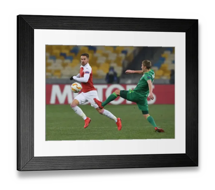 Framed Print : Aaron Ramsey vs. Igor Perduta: Clash in the Europa League between Arsenal and Vorskla Poltava