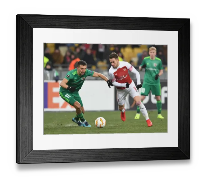 Framed Print : Aaron Ramsey vs. Vyacheslav Sharpar: Clash in the Europa League between Arsenal and Vorskla Poltava Framed Print : Aaron Ramsey vs. Vyacheslav Sharpar: Clash in the Europa League between Arsenal and Vorskla Poltava