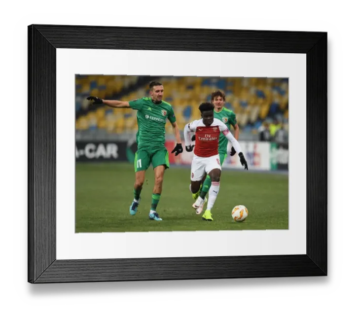 Framed Print : Bukayo Saka vs. Vyacheslav Sharpar: Arsenal's Rising Star Faces Off Against Vorskla Defender in Europa League Clash Framed Print : Bukayo Saka vs. Vyacheslav Sharpar: Arsenal's Rising Star Faces Off Against Vorskla Defender in Europa League Clash