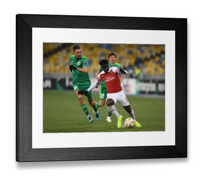 Framed Print : Bukayo Saka vs. Vyacheslav Sharpar: Arsenal's Rising Star Clashes in Europa League Showdown