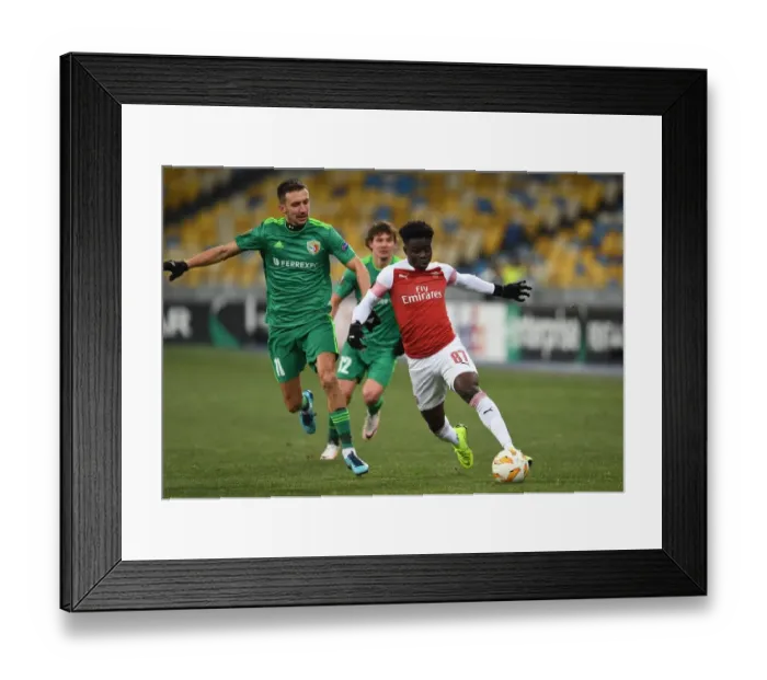Framed Print : Arsenal's Bukayo Saka Clashes with Vyacheslav Sharpar in Europa League Battle Framed Print : Arsenal's Bukayo Saka Clashes with Vyacheslav Sharpar in Europa League Battle