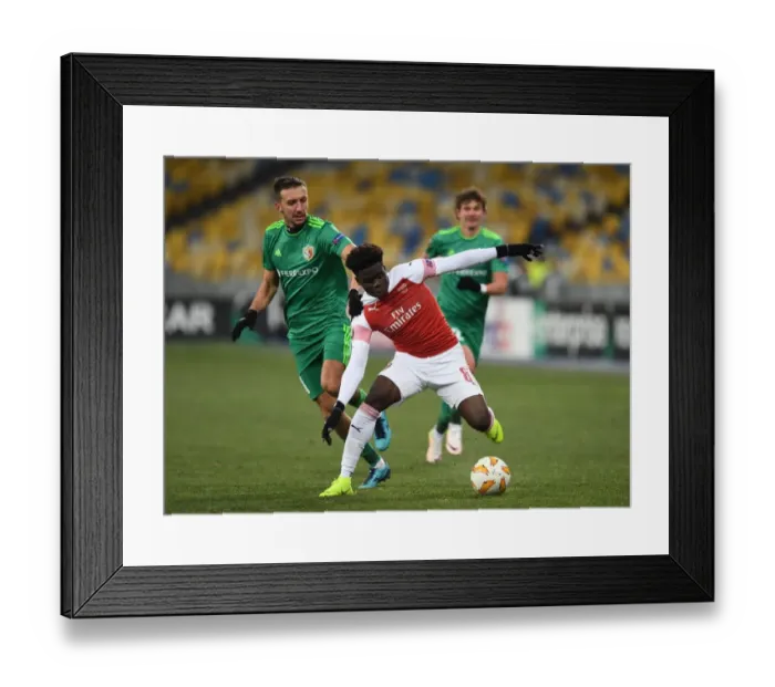 Framed Print : Arsenal's Bukayo Saka Faces Off Against Vyacheslav Sharpar in Europa League Clash Framed Print : Arsenal's Bukayo Saka Faces Off Against Vyacheslav Sharpar in Europa League Clash