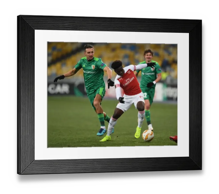 Framed Print : Arsenal's Bukayo Saka Faces Off Against Vyacheslav Sharpar in Europa League Clash Framed Print : Arsenal's Bukayo Saka Faces Off Against Vyacheslav Sharpar in Europa League Clash