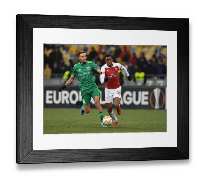 Framed Print : Joe Willock vs. Vyacheslav Sharpar: Arsenal Star Clashes with Vorskla Player in Europa League Match Framed Print : Joe Willock vs. Vyacheslav Sharpar: Arsenal Star Clashes with Vorskla Player in Europa League Match
