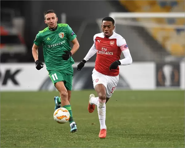 Arsenal's Joe Willock Clashes with Vyacheslav Sharpar in Europa League Battle