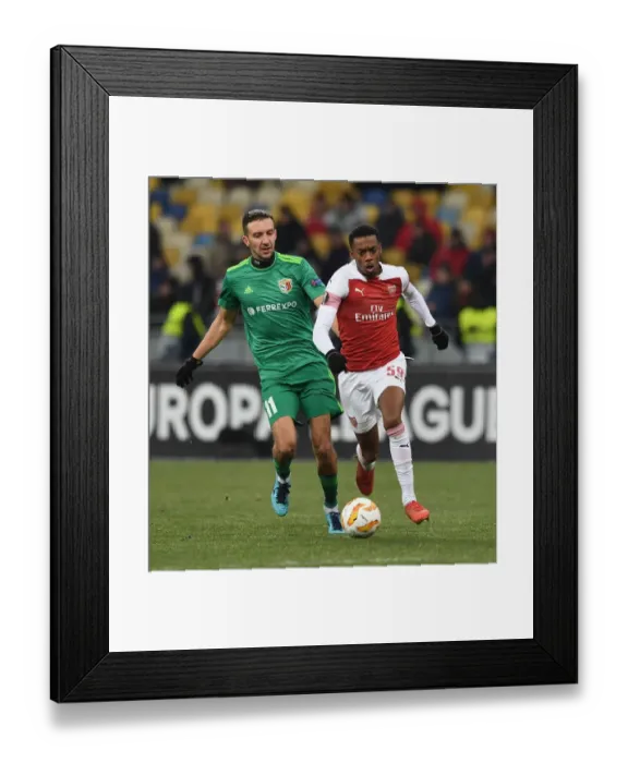 Framed Print : Joe Willock vs. Vyacheslav Sharpar: Intense Clash in Arsenal's Europa League Battle against Vorskla Poltava Framed Print : Joe Willock vs. Vyacheslav Sharpar: Intense Clash in Arsenal's Europa League Battle against Vorskla Poltava