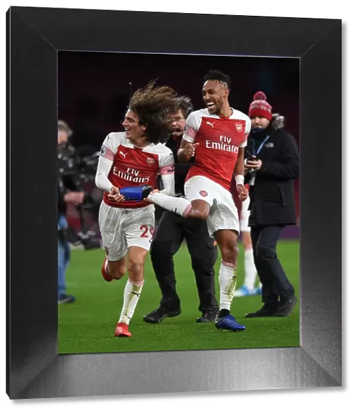 Arsenal Celebrate: Guendouzi and Aubameyang Rejoice in Arsenal's Victory over Tottenham