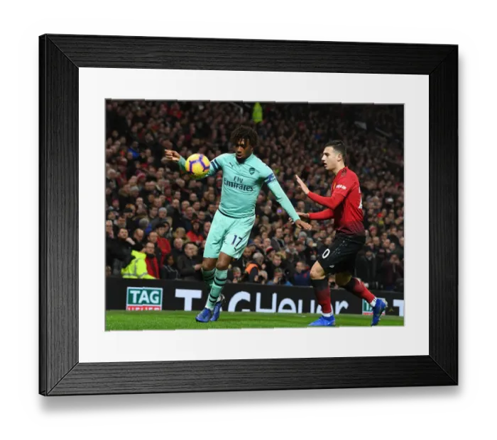 Framed Print : Arsenal's Alex Iwobi Clashes with Manchester United's Matteo Darmian in Premier League Showdown Framed Print : Arsenal's Alex Iwobi Clashes with Manchester United's Matteo Darmian in Premier League Showdown