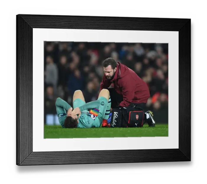 Framed Print : Arsenal's Aaron Ramsey Receives Treatment During Manchester United Clash (2018-19)