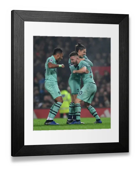 Framed Print : Arsenal's Triumph: Mustafi, Aubameyang, and Bellerin Celebrate First Goal Against Manchester United (2018-19)