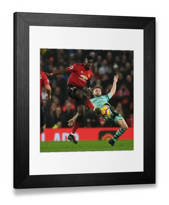 Framed Print : Mustafi vs Pogba: A Footballing Battle in the Premier League Clash between Manchester United and Arsenal FC