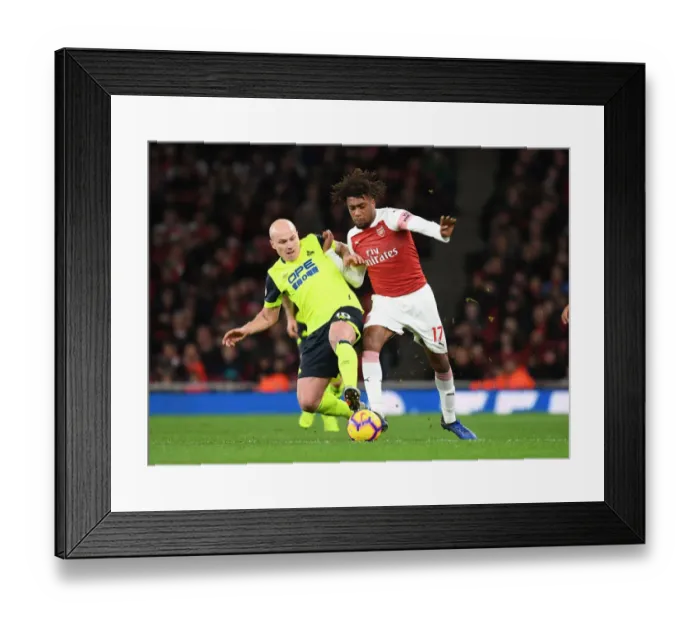 Framed Print : Arsenal's Alex Iwobi Clashes with Huddersfield's Aaron Mooy in Premier League Showdown