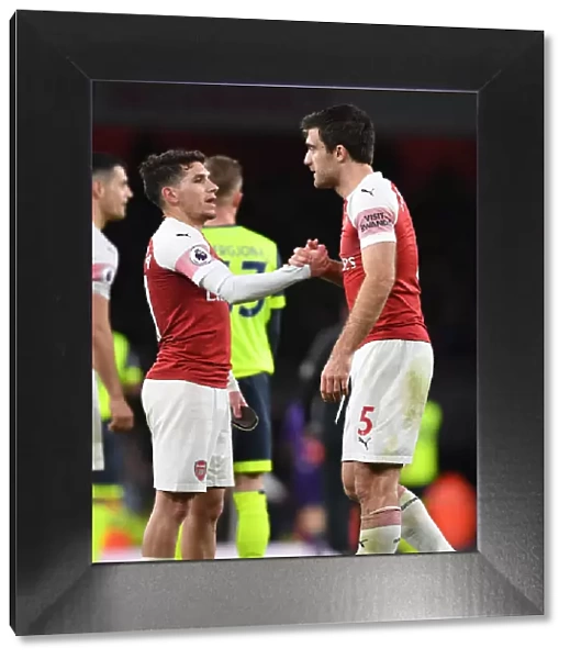 Arsenal's Torreira and Sokratis Celebrate Victory Over Huddersfield Town